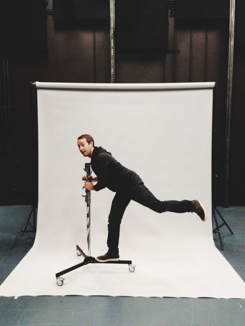 John Keatley rolling on a light stand at a photo shoot.